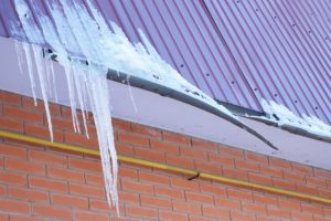 Broken Rain Gutters from ice dam on roof of a home